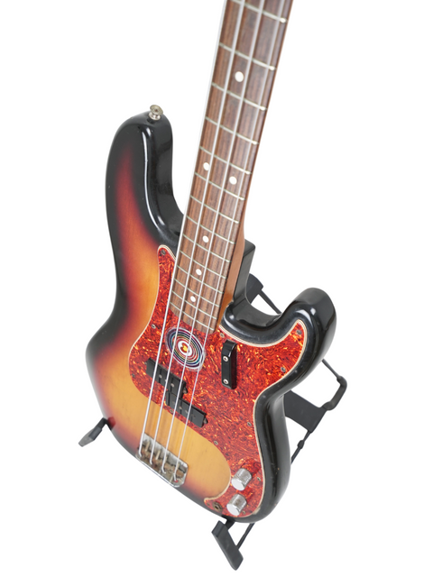 Sunburst electric bass guitar with four strings on a white background.