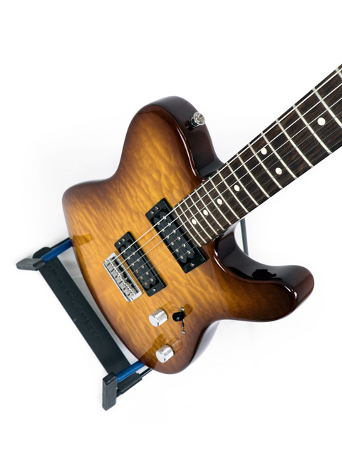 Sunburst electric guitar with a dark fretboard on a stand against a white background.