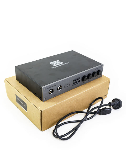 The Seymour Duncan PowerStage 700 amplifier in black, featuring a power cord and remote control for easy operation and setup.
