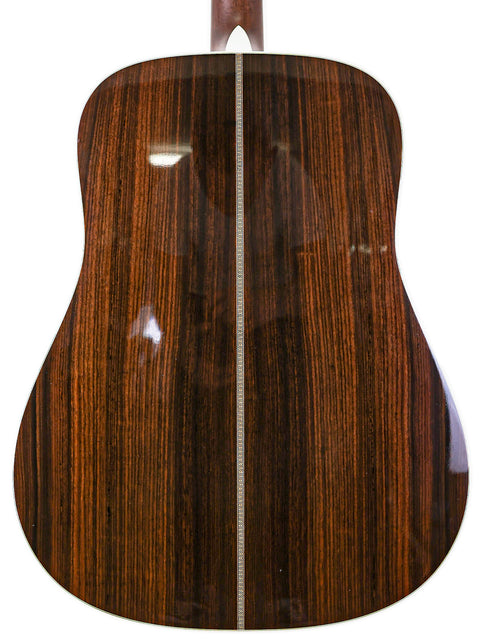 The back of a 2006 Martin HD-28 acoustic guitar, featuring a warm brown finish and elegant design details.