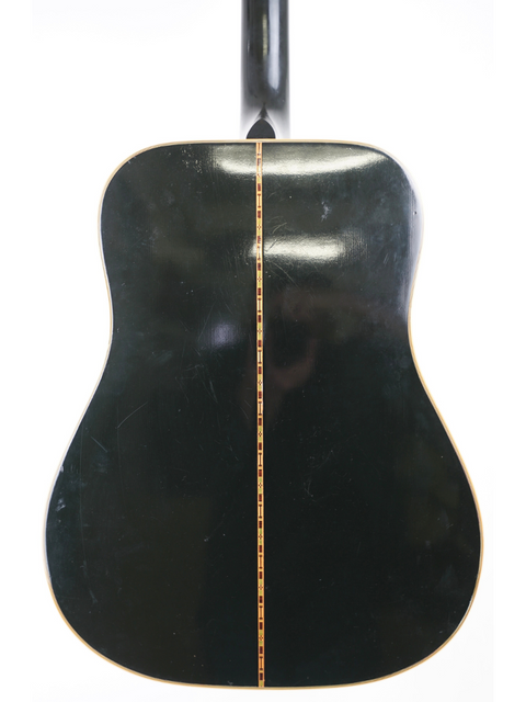 The back of a classic 1977 Gibson Dove Custom acoustic guitar, beautifully finished in black, capturing its vintage essence.