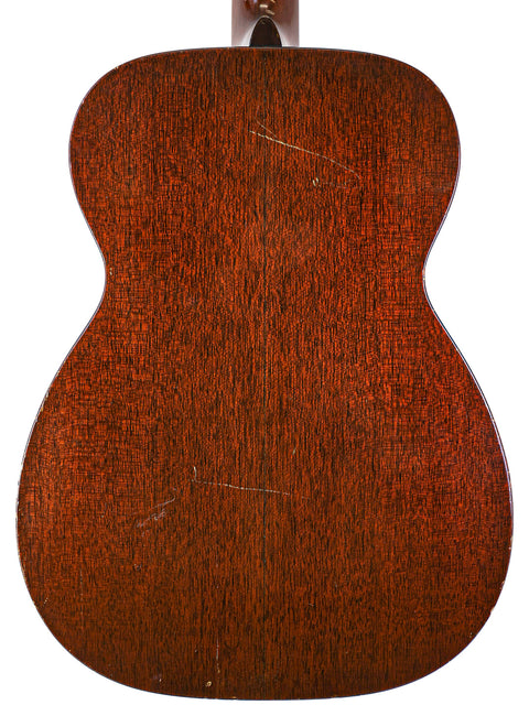 The back view of a 1954 Vintage Martin 00-17 acoustic guitar, highlighting its classic wood finish and intricate details.