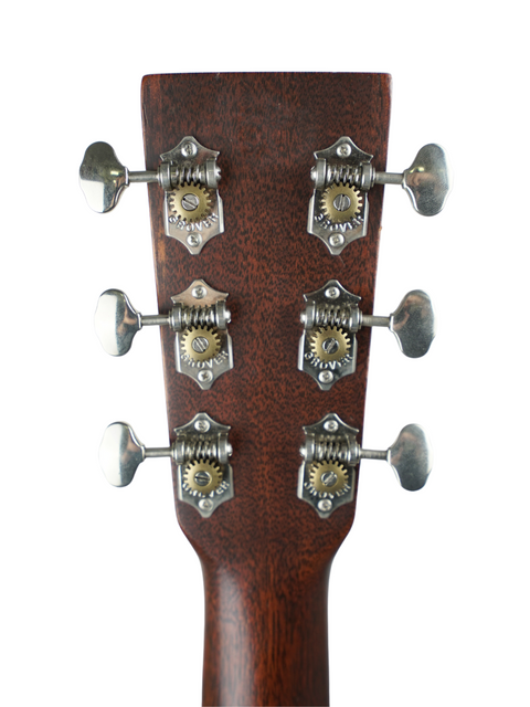 The headstock of a 2016 Martin 000-15M acoustic guitar, featuring four knobs, emphasizing its elegant design and quality.