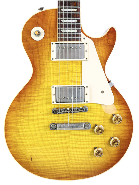 The iconic Gibson Les Paul Custom in a vibrant sunburst, representing the 2009 '59 Reissue model with exquisite detailing.
