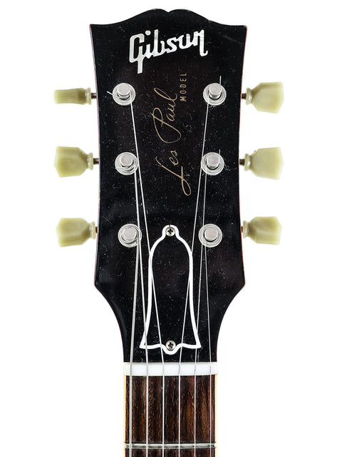 The image features a Gibson Les Paul Custom Shop '59 Reissue guitar from 2009, highlighting its iconic shape and finish.