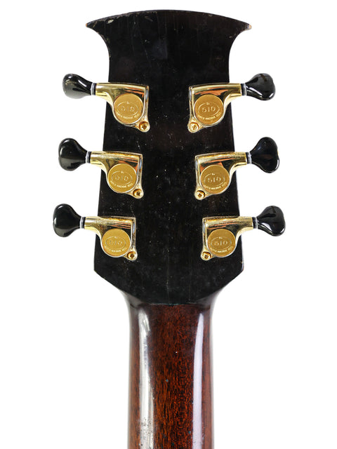 The image shows a black guitar headstock, featuring the signature of Jim Williams, dated 2005 in Australia.