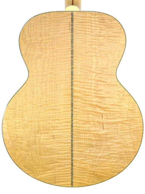 The wooden back of a 1999 Gibson SJ-200 acoustic guitar, highlighting its elegant design and craftsmanship.