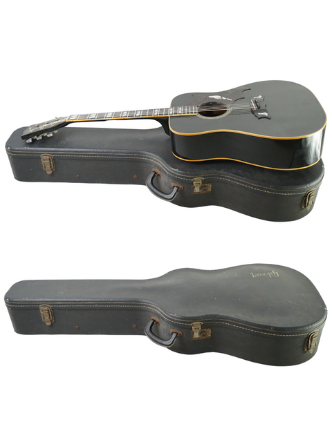 Two black guitars, featuring a 1977 Gibson Dove Custom, elegantly positioned with their cases on a stark white surface.