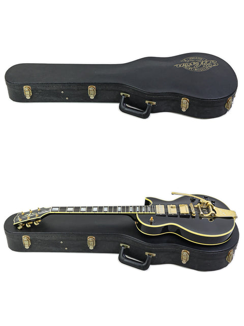 Two guitars displayed in black cases with gold accents, featuring the 2004 Gibson Custom Shop 1957 Les Paul Custom B3 'Black Beauty'.
