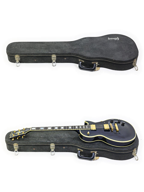 Two guitars positioned uniquely, showcasing a 1991 Gibson Custom Shop Les Paul Custom model.