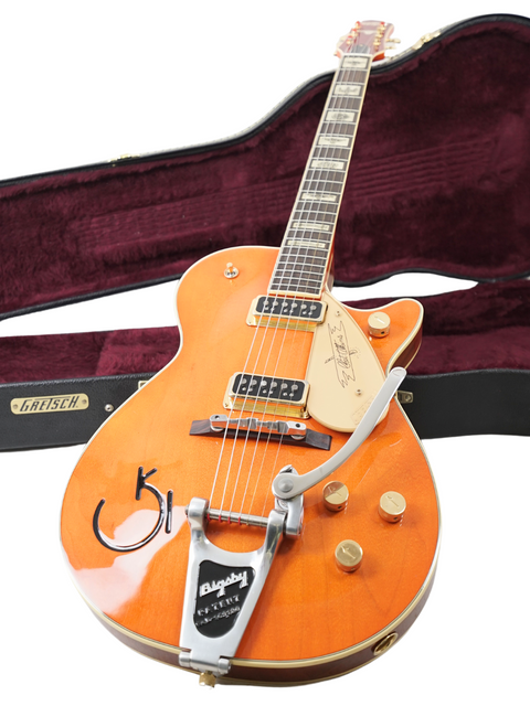 Vibrant orange Gretsch G-60S, a 2003 Japan reissue. Perfect for players wanting a unique and stylish instrument!