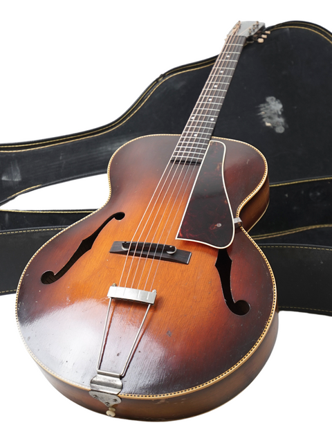 Vintage 1938 Gibson Kalamazoo KG-32 guitar with its case, representing a timeless piece of musical history and artistry.
