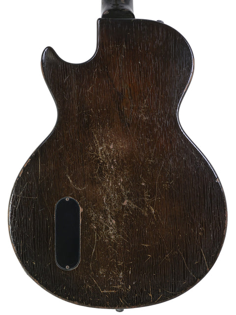 Vintage 1958 Gibson Les Paul Jr guitar viewed from the back, emphasizing its wooden body and distinctive TV Yellow color.