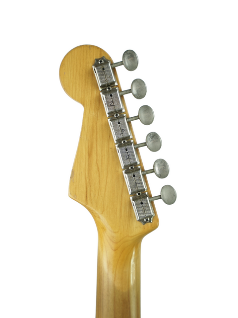  Vintage 1959 Fender Stratocaster guitar head in close-up, set against a white background, capturing its iconic design.