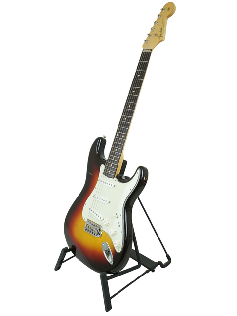 Vintage 1961 Fender Stratocaster guitar elegantly positioned on a stand with a bright white background.
