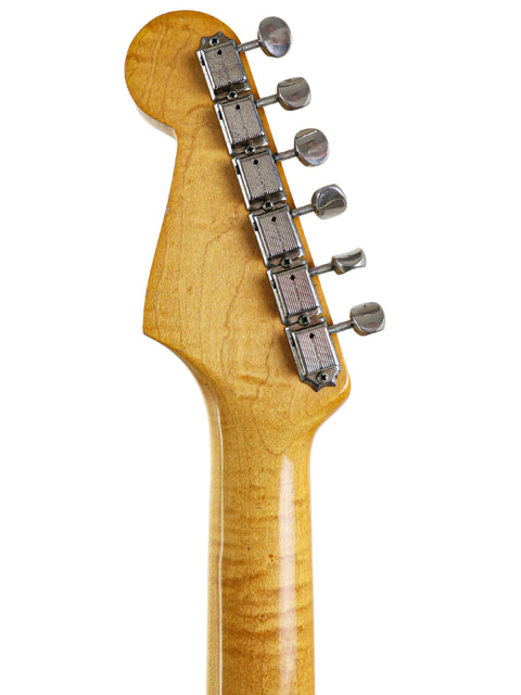 Vintage 1963 Fender L-Series Stratocaster neck in close-up, set against a bright white background for emphasis.