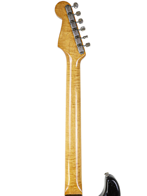 Vintage 1963 Fender L-Series Stratocaster, showcasing a stylish black body and eye-catching yellow neck, ideal for rock lovers.