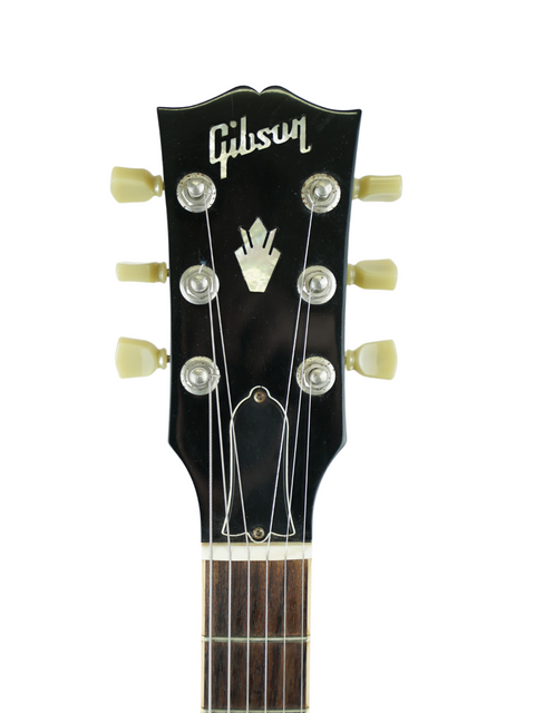 Vintage 1964 Gibson Les Paul Custom guitar displayed with a 2009 Gibson Custom Shop ES-339 Memphis, highlighting their elegance.