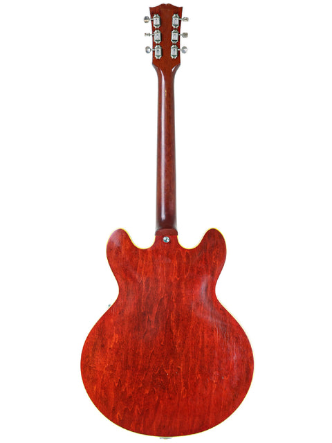 Vintage 1965 Gibson ES-330 electric guitar viewed from the back, highlighting its red body.