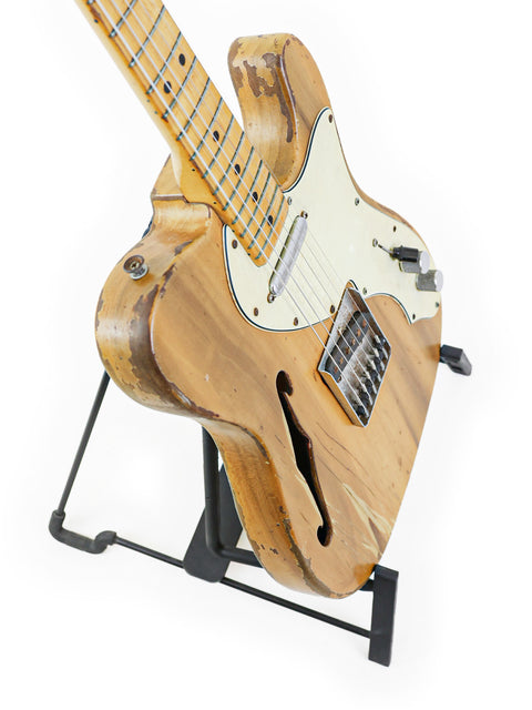Vintage 1971 Fender Telecaster Thinline guitar displayed on a stand, featuring a rich wooden body and iconic style.