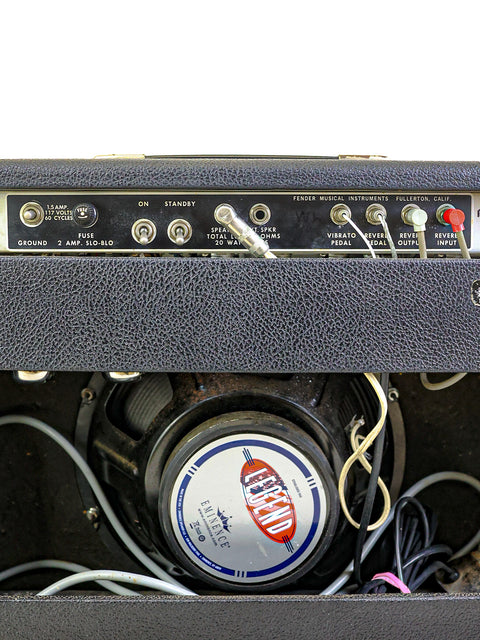 Vintage 1977 Fender Deluxe Reverb amp up close, showing off its wires and classic 12" speaker in a stylish design.