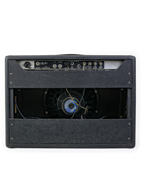 Vintage Fender Deluxe Reverb Blackface Combo amplifier in black against a clean white background, showcasing its classic design.