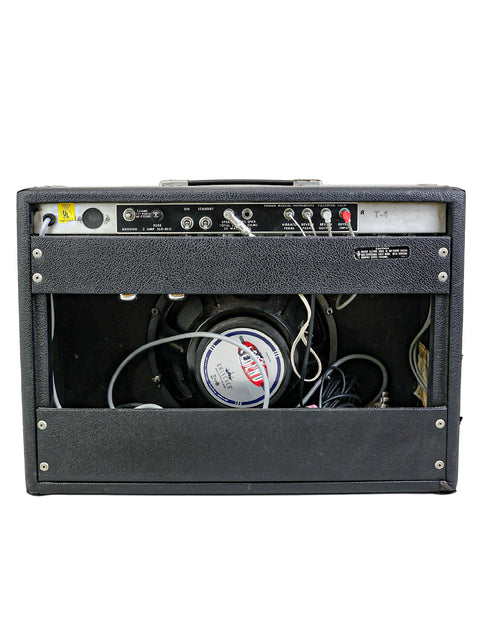Vintage Fender Deluxe Reverb amp in black, complete with a microphone and wires, ideal for a nostalgic music experience.