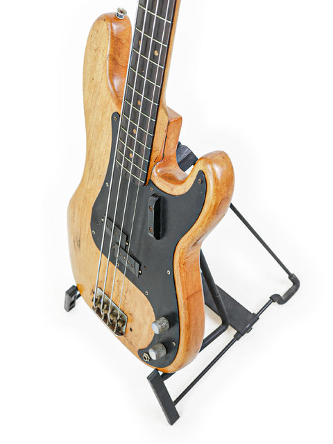 Vintage Fender L-Series Precision Bass from 1963, elegantly positioned on a stand with a white background.