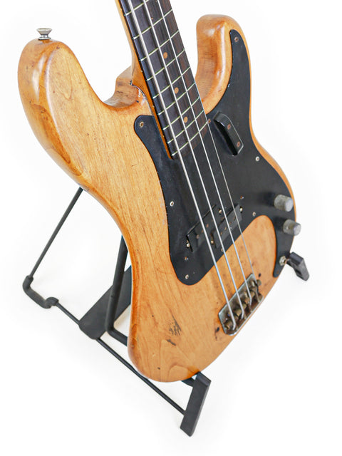 Vintage Fender L-Series Precision Bass from 1963 on a stand, highlighted by a simple white background.
