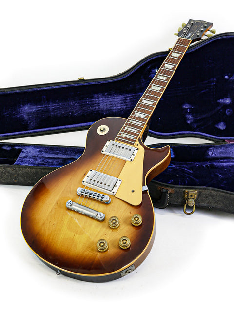 Vintage Gibson Les Paul Standard guitar from 1979, housed in a case, presented on a white backdrop.