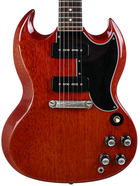 Vintage Gibson SG Special guitar with a red body and black pick-ups, showcasing its classic design from 1964/5.