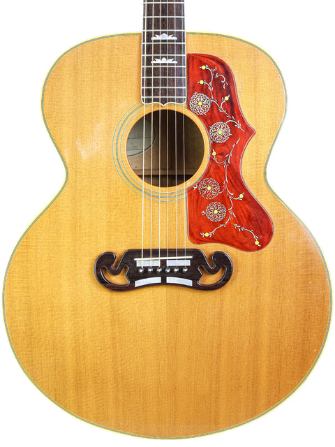 Vintage Gibson SJ-200 guitar from 1984 featuring a red and white flower design on the back.