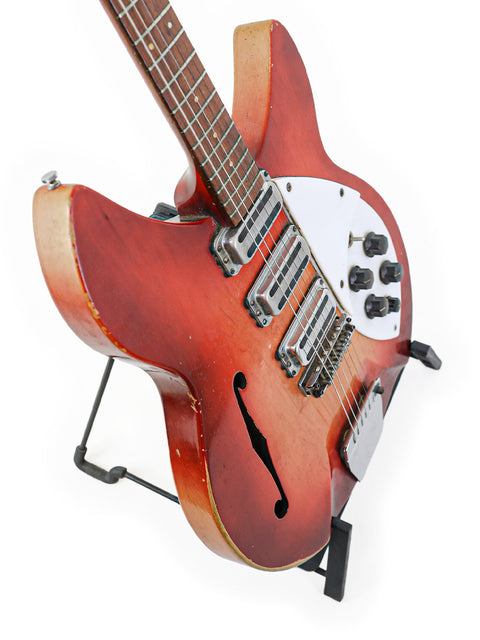 Vintage Rickenbacker 1998 (345) Rose Morris guitar displayed on a stand, showcasing its classic design and craftsmanship.