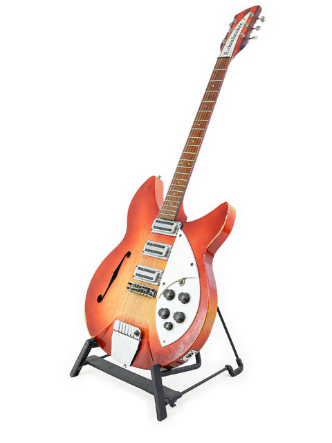 Vintage Rickenbacker 1998 (345) Rose Morris guitar resting on a stand, highlighted by a white background.