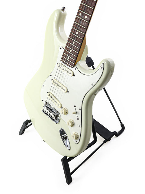 White Fender Custom Shop Jeff Beck Signature Stratocaster guitar resting on a sleek black stand.