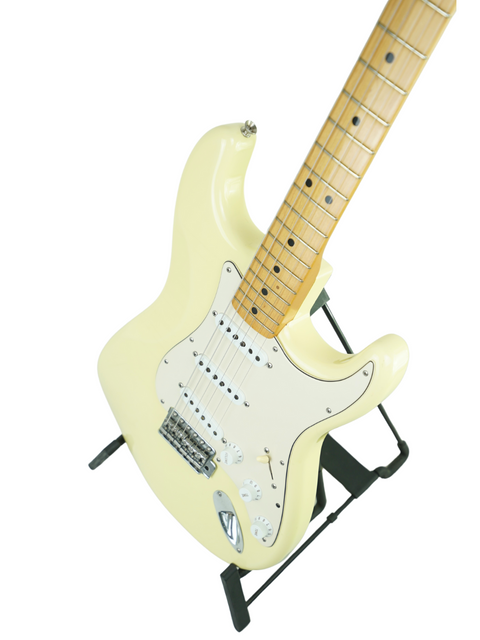 White electric guitar on a stand, featuring the 2006 Fender Custom Shop Masterbuilt Reverse Proto Stratocaster, 1 of 100.