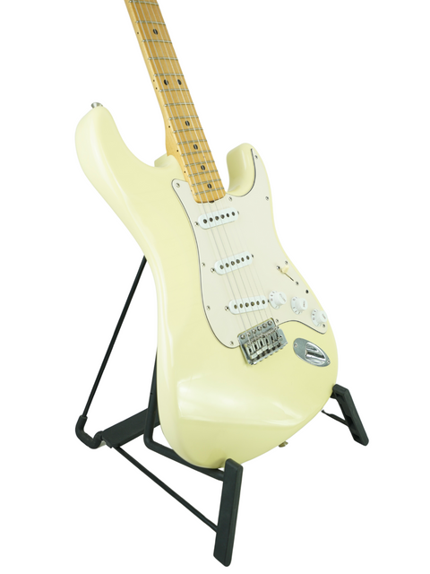 White electric guitar on a stand, featuring the limited edition Fender Custom Shop Masterbuilt Dennis Galuszka design.