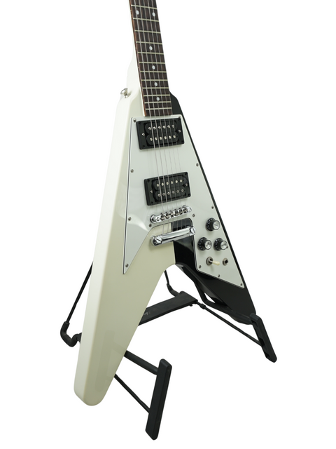 White electric guitar with a distinctive V-shape on a stand, isolated on a white background.