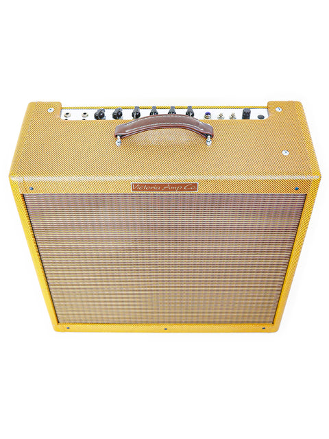Yellow 'Bassman' guitar amplifier by Victoria, model 45410-T, with a wooden handle, made in the USA, 2007.