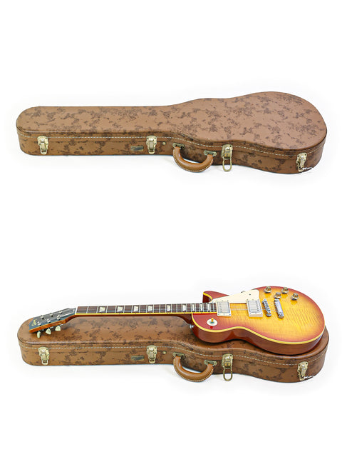 brown guitar case holds a red Gibson Custom Shop 1959 Reissue Les Paul R9 from 2004, showcasing its classic design.