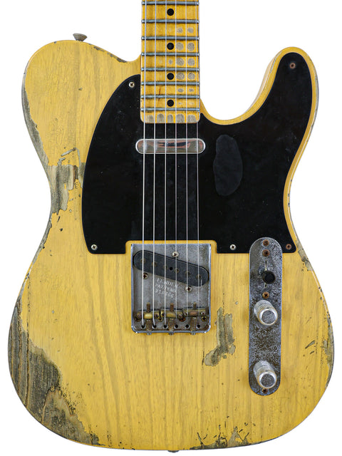 vintage-style yellow guitar, the Fender Custom Shop '53 Telecaster Heavy Relic, with a striking black pickguard.