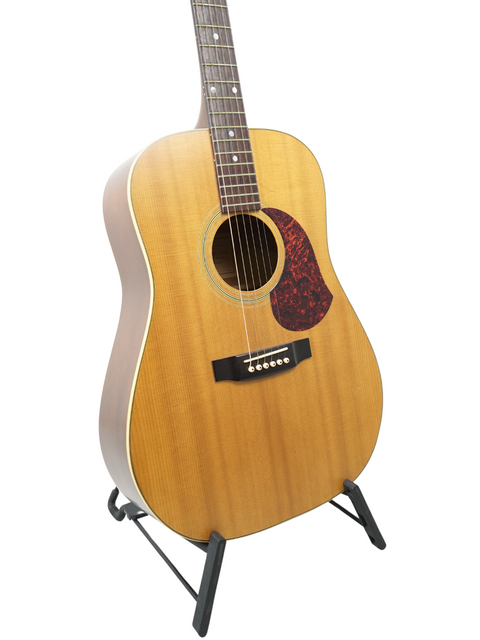 vintage 1991 Maton CW80/6 guitar resting on a stand, set against a bright white backdrop for a striking visual.
