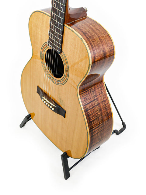 vintage Matchless Lightning 15 Combo guitar displayed on a stand, featuring a sleek body against a bright white backdrop.