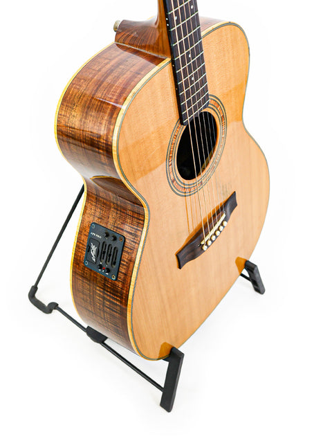 vintage Matchless Lightning 15 Combo guitar displayed on a stand, featuring a sleek body against a bright white backdrop.