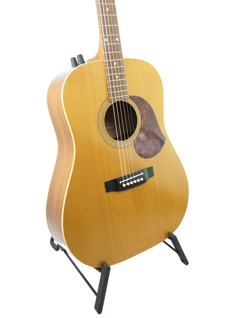vintage Maton EM300 Natural Series guitar from 1991 resting on a stand, with a bright white backdrop.