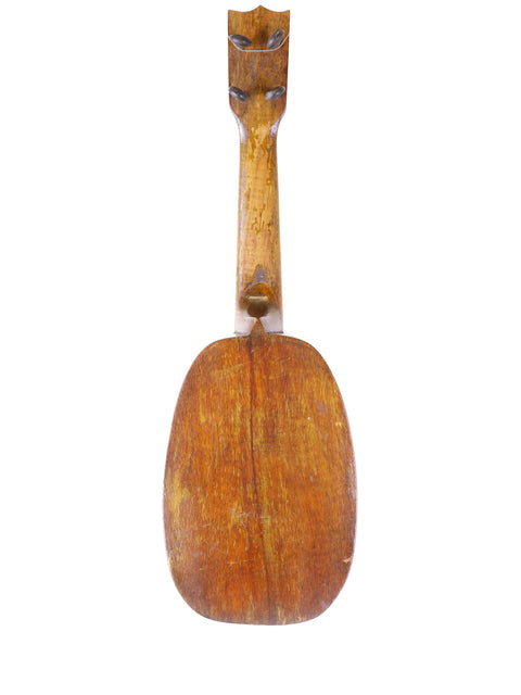 1930 Kamaka Pineapple Ukulele with a wooden body and head, a vintage instrument reflecting the charm of Hawaiian music.