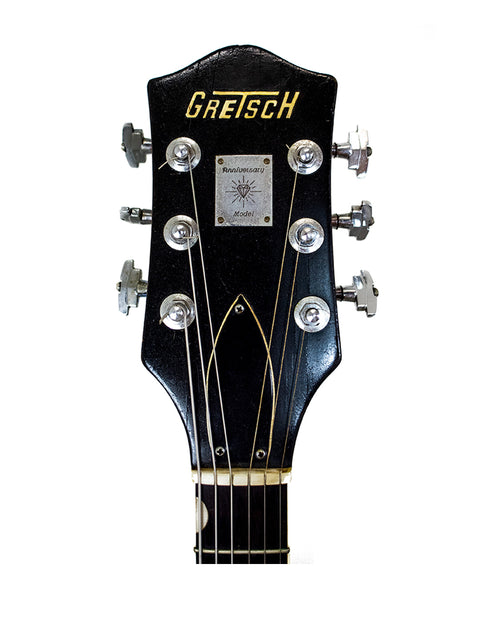  1964 Gretsch Double Anniversary 6117 guitar in black, prominently displaying the "Gretsch" name on its body.