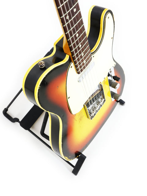 1966 Vintage Fender Custom Telecaster with a distinctive yellow and black body, highlighting its classic design.