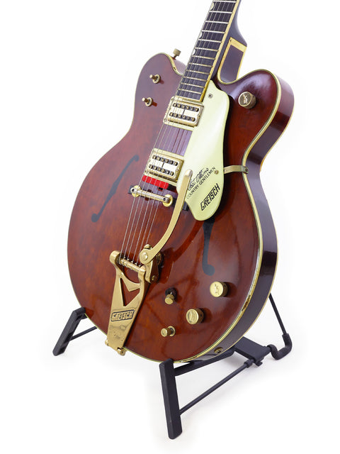 1967 Gretsch 6122 Chet Atkins guitar featuring a brown body and gold hardware, showcasing classic craftsmanship.