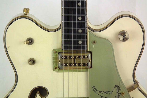 1968 Gretsch 6136 White Falcon guitar featuring a striking green headstock and elegant gold pickguard, ideal for any player.